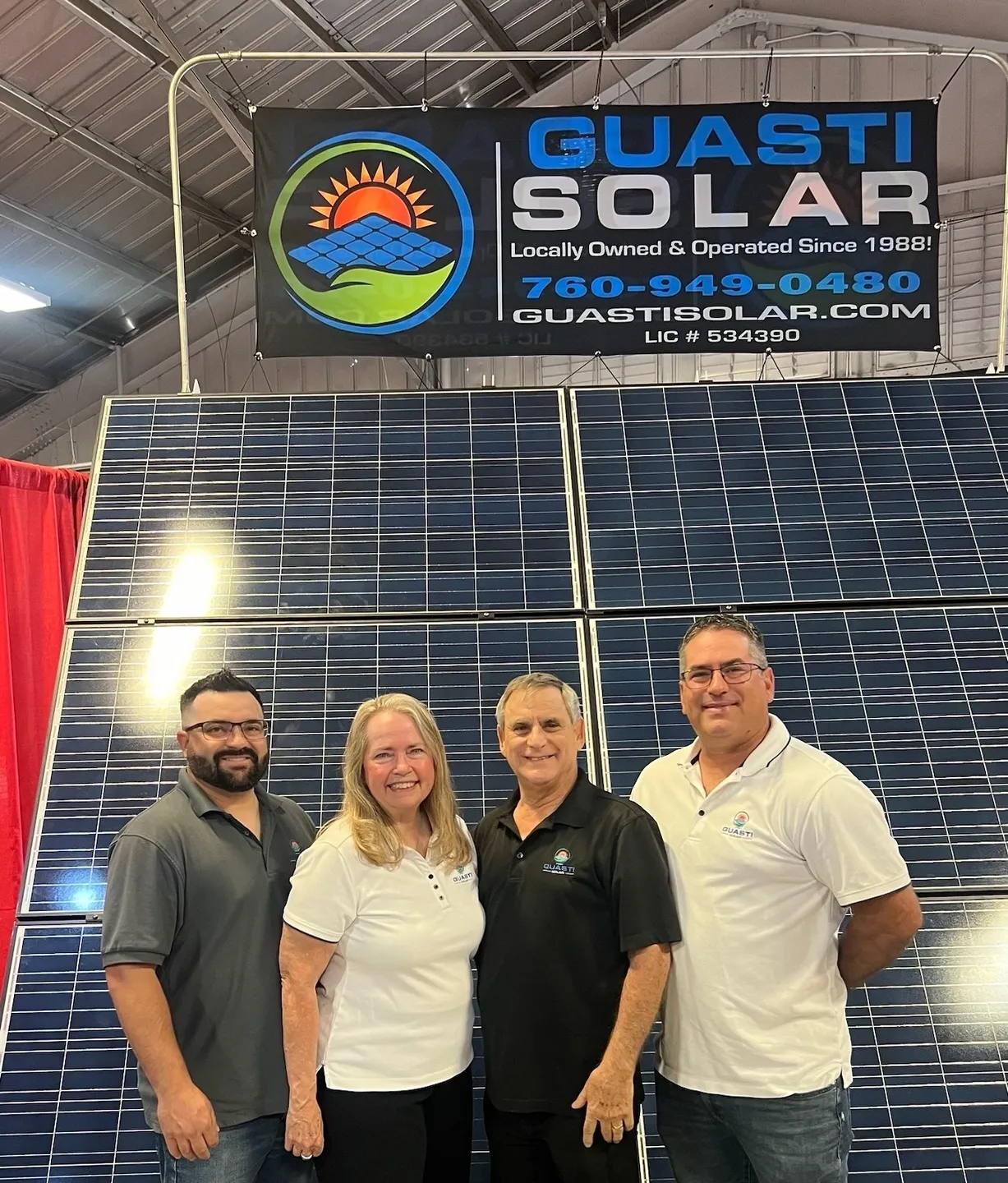 A group of people standing in front of a solar panel.